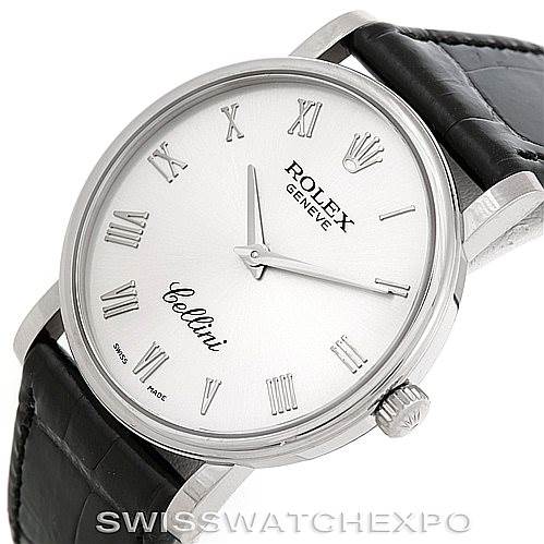 The image shows a Rolex Cellini 5115 Men's White Gold Silver Dial 5115 Men's White Gold Silver Dial watch at a front-right angle, featuring a white dial with Roman numerals, silver hands, and a black leather strap.