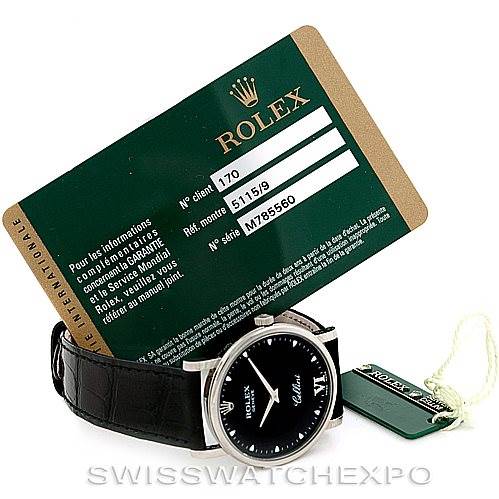 The image shows a Rolex Cellini 5115 Men's White Gold Black Dial 5115 Men's White Gold Black Dial watch from a front angle, along with a warranty card and a tag.