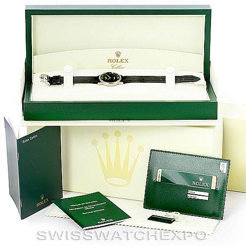 The image shows a Rolex Cellini 5115 Men's White Gold Black Dial 5115 Men's White Gold Black Dial watch in its box with accompanying documents and accessories laid out around the box.
