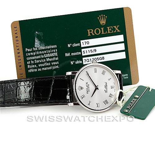 The image shows a Rolex Cellini 5115 Men's White Gold Silver Dial 5115 Men's White Gold Silver Dial watch laying flat with a green Rolex card and tag positioned above and beside it.