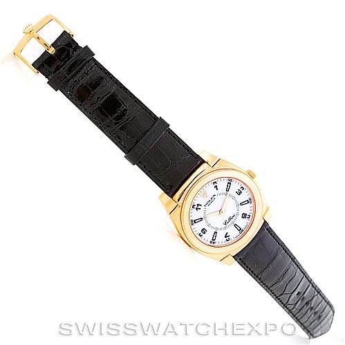 The image shows a top view of a Rolex Cellini 5330 Men's Yellow Gold White Dial 5330 Men's Yellow Gold White Dial watch, displaying the face, gold case, and black leather strap with a buckle.