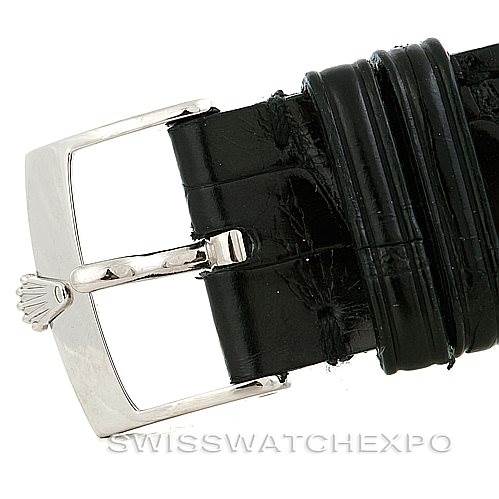 This image shows a close-up of the buckle and part of the black leather strap of a Rolex Cellini 5330 Men's White Gold White Dial 5330 Men's White Gold White Dial watch at an angle where the clasp is open.