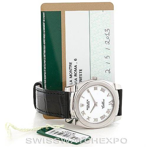 The image shows a Rolex Cellini 5330 Men's White Gold White Dial 5330 Men's White Gold White Dial watch from a frontal angle, accompanied by a green tag and warranty card.