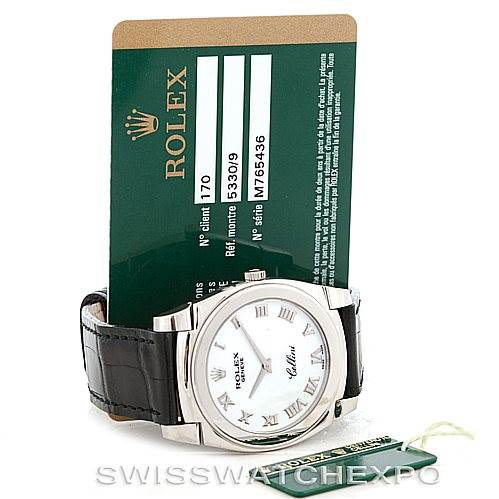 The image shows a Rolex Cellini 5330 Men's White Gold White Dial 5330 Men's White Gold White Dial watch with its black leather strap, positioned at a slight angle along with a Rolex warranty card.
