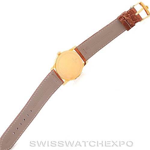 This image shows the back view of a Rolex Cellini 5116 Men's Yellow Gold Champagne Dial 5116 Men's Yellow Gold Champagne Dial watch, showcasing the brown leather strap and gold case back.