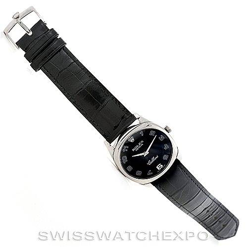 The image shows a top-down view of a Rolex Cellini 4233 Men's White Gold Black Dial 4233 Men's White Gold Black Dial watch, highlighting the black dial and leather strap.