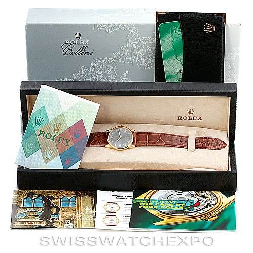 The image shows a Rolex Cellini 5116 Men's Yellow Gold Grey Dial 5116 Men's Yellow Gold Grey Dial watch in a presentation box with various accompanying brochures and documents.