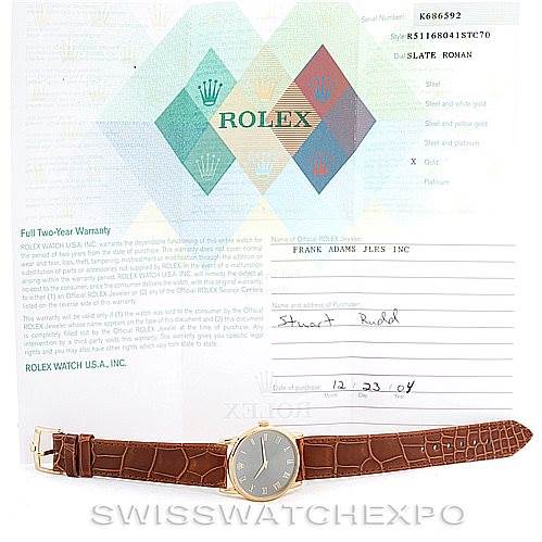 The image shows a Rolex Cellini 5116 Men's Yellow Gold Grey Dial 5116 Men's Yellow Gold Grey Dial model watch laid flat, accompanied by its warranty papers and documentation.