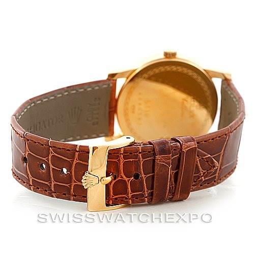 The image shows the back of a Rolex Cellini 5116 Men's Yellow Gold Grey Dial 5116 Men's Yellow Gold Grey Dial watch, featuring its brown leather strap and gold clasp.