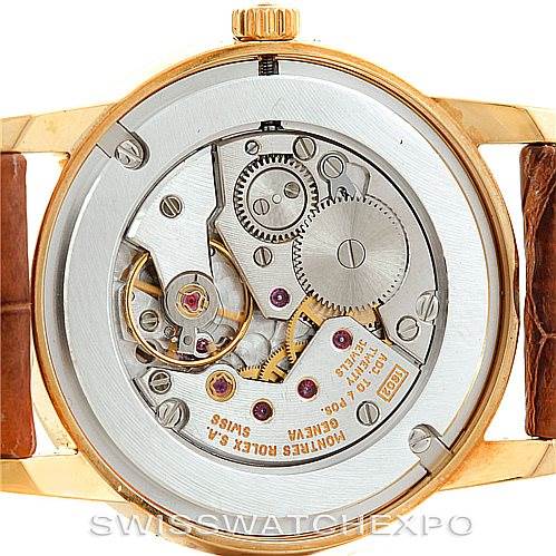 The image shows the back view of a Rolex Cellini 5116 Men's Yellow Gold Grey Dial 5116 Men's Yellow Gold Grey Dial watch, displaying its intricate mechanical movement and inner components.