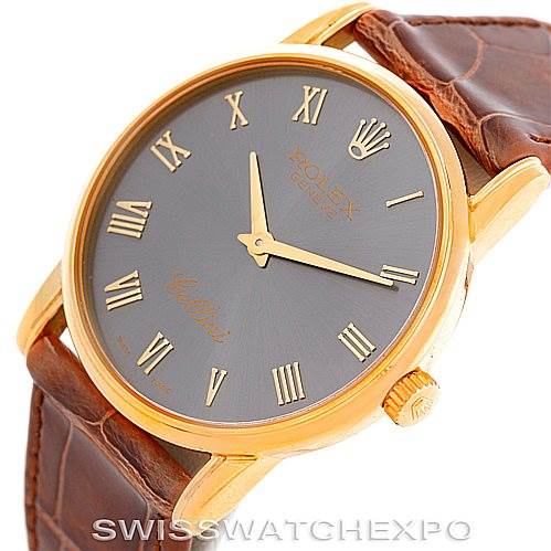 The image shows a close-up, angled view of a Rolex Cellini 5116 Men's Yellow Gold Grey Dial 5116 Men's Yellow Gold Grey Dial watch, highlighting its dial, crown, and leather strap.