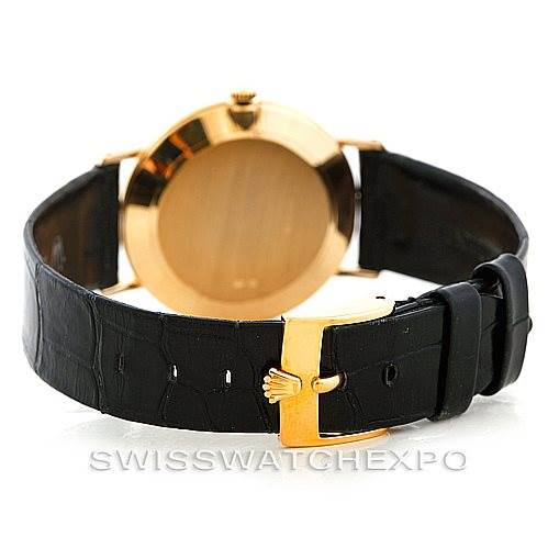 The image shows the back view of a Rolex Cellini 4112 Men's Yellow Gold White Dial 4112 Men's Yellow Gold White Dial watch with a gold case and a black leather strap, highlighting the clasp and crown.