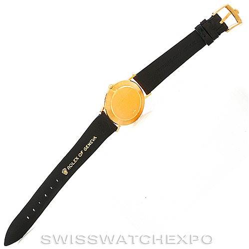 The Rolex Cellini 4112 Men's Yellow Gold Champagne Dial 4112 Men's Yellow Gold Champagne Dial watch is shown from a top view, displaying its gold round case and black leather strap.