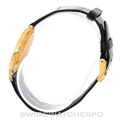 The image shows a side profile of a Rolex Cellini 4112 Men's Yellow Gold Champagne Dial 4112 Men's Yellow Gold Champagne Dial watch, highlighting its gold case, black leather strap, and crown.