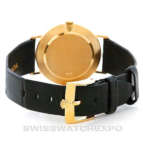 The Rolex Cellini 4112 Men's Yellow Gold Champagne Dial 4112 Men's Yellow Gold Champagne Dial watch is shown from the back, displaying its leather strap and gold buckle.