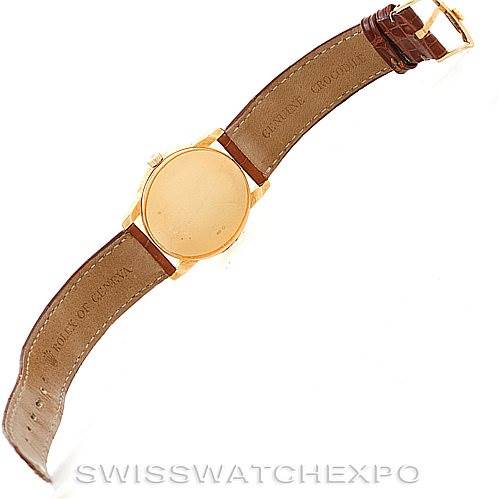 This image shows the back side of a Rolex Cellini 5116 Men's Yellow Gold Champagne Dial 5116 Men's Yellow Gold Champagne Dial watch, including its leather strap and gold case, viewed from above.