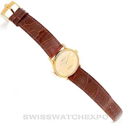 The image shows a Rolex Cellini 5116 Men's Yellow Gold Champagne Dial 5116 Men's Yellow Gold Champagne Dial watch at an angled top-down view, highlighting the dial, case, and leather strap.