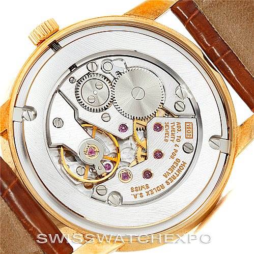 This image shows the back view of a Rolex Cellini 5116 Men's Yellow Gold Champagne Dial 5116 Men's Yellow Gold Champagne Dial watch, displaying its intricate internal mechanisms and gears.