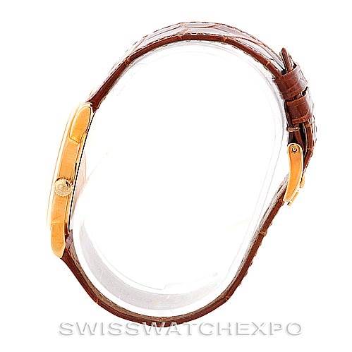 The image shows a Rolex Cellini 5116 Men's Yellow Gold Champagne Dial 5116 Men's Yellow Gold Champagne Dial watch from a side angle, highlighting its case and brown leather strap.