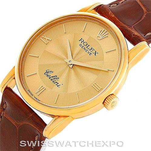 This image shows a close-up angle of a Rolex Cellini 5116 Men's Yellow Gold Champagne Dial 5116 Men's Yellow Gold Champagne Dial watch, displaying the gold dial, crown, and brown leather strap.