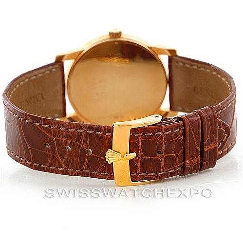 The image shows the back of a Rolex Cellini 5116 Men's Yellow Gold Champagne Dial 5116 Men's Yellow Gold Champagne Dial watch with a gold buckle and brown leather strap.