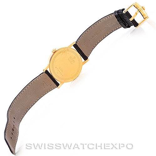 This image shows the back view of a Rolex Cellini 5115 Men's Yellow Gold  5115 Men's Yellow Gold  watch, displaying its gold case and brown leather strap with a buckle.