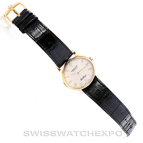 The Rolex Cellini 5115 Men's Yellow Gold  5115 Men's Yellow Gold  watch is shown from a top-down angle, displaying its dial, strap, clasp, and buckle.