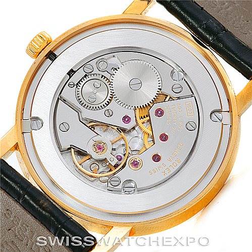 The image shows the back view of a Rolex Cellini 5115 Men's Yellow Gold  5115 Men's Yellow Gold  watch, revealing its intricate inner mechanical movement.