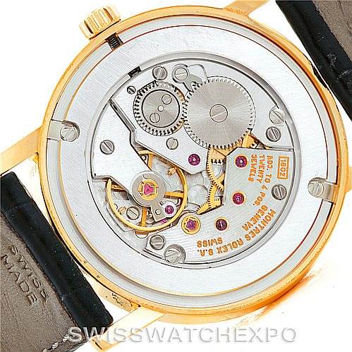 This image shows the back view of a Rolex Cellini 5115 Men
s Yellow Gold Beige Dial 5115 Men
s Yellow Gold Beige Dial watch, displaying its intricate mechanical movement and inner components.