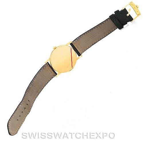 This image shows a top-down view of a Rolex Cellini 5115 Men
s Yellow Gold Beige Dial 5115 Men
s Yellow Gold Beige Dial watch, displaying both the front and back of the leather strap and the watch face.