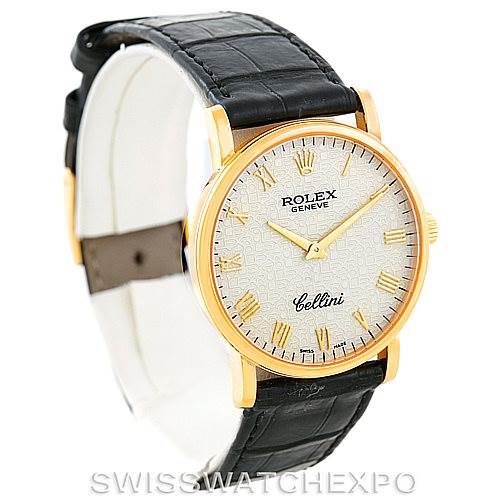 The image shows a Rolex Cellini 5115 Men
s Yellow Gold Beige Dial 5115 Men
s Yellow Gold Beige Dial watch from a three-quarter angle, highlighting its dial, gold casing, and black leather strap.