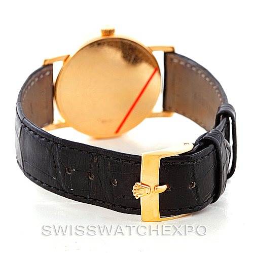 This Rolex Cellini 5115 Men
s Yellow Gold Beige Dial 5115 Men
s Yellow Gold Beige Dial watch is shown from the back, highlighting the leather strap and gold clasp.