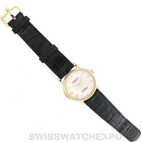 The Rolex Cellini 5115 Men
s Yellow Gold Beige Dial 5115 Men
s Yellow Gold Beige Dial watch is shown from a top-down angle, displaying the full watch and its black leather strap.