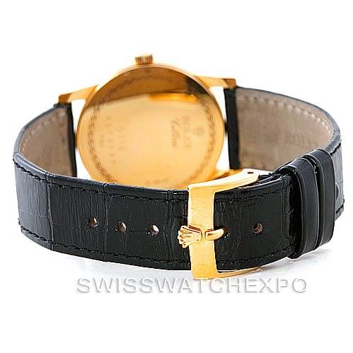 The image shows the back of a Rolex Cellini 5116 Men's Yellow Gold Mother of Pearl Dial 5116 Men's Yellow Gold Mother of Pearl Dial watch highlighting its black leather strap and gold buckle.