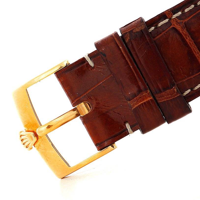 This image shows a close-up of the leather strap and gold buckle of a Rolex Cellini 4233 Men's Yellow Gold White Dial 4233 Men's Yellow Gold White Dial watch.