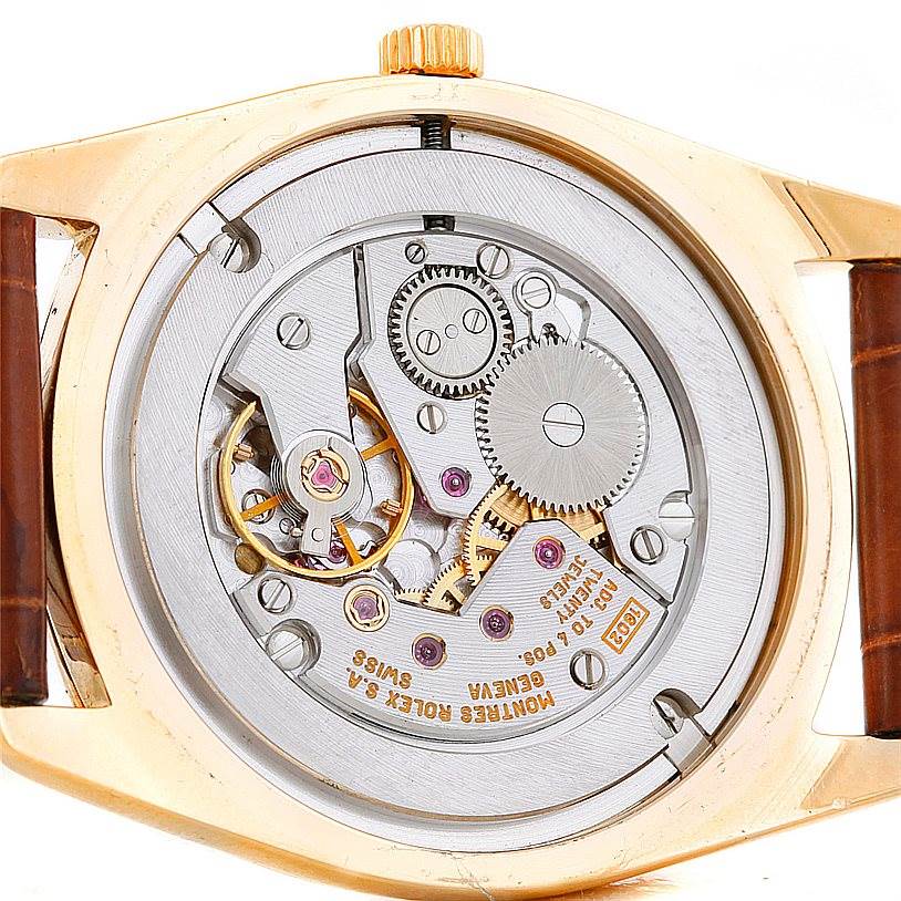 The image shows the back view of a Rolex Cellini 4233 Men's Yellow Gold White Dial 4233 Men's Yellow Gold White Dial model, revealing its intricate mechanical movement and internal components.