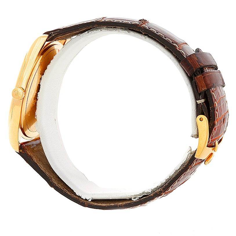 This image shows a side view of the Rolex Cellini 4233 Men's Yellow Gold White Dial 4233 Men's Yellow Gold White Dial watch, highlighting its crown, case, and leather strap.