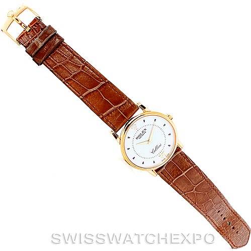 The watch is a Rolex Cellini 5116 Men's Yellow Gold Silver Dial 5116 Men's Yellow Gold Silver Dial model shown at a top-down angle, featuring the face and the brown leather strap.