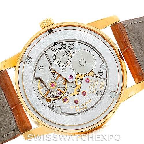 The image shows the back view of a Rolex Cellini 5116 Men's Yellow Gold Silver Dial 5116 Men's Yellow Gold Silver Dial watch, highlighting its intricate movement and mechanism.