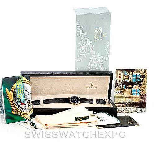 The image shows a Rolex Cellini 5115 Men's White Gold Black Dial 5115 Men's White Gold Black Dial watch with its box, packaging, and accompanying accessories arranged on a surface.