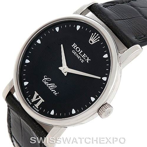 The image shows a Rolex Cellini 5115 Men's White Gold Black Dial 5115 Men's White Gold Black Dial watch at an angled view, highlighting the black dial, crown, and black leather strap.