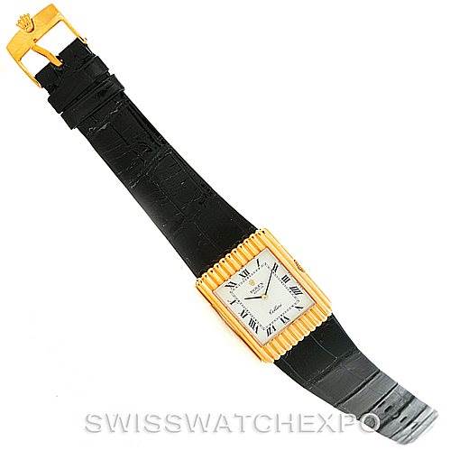 The image shows a top view of a Rolex Cellini 4016 Men's Yellow Gold White Dial 4016 Men's Yellow Gold White Dial watch, highlighting its black strap, rectangular gold face, and clasp.