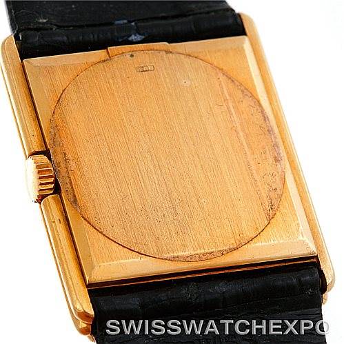 The image shows the back of a Rolex Cellini 4016 Men's Yellow Gold White Dial 4016 Men's Yellow Gold White Dial watch, highlighting its gold case and black strap from a close-up angle.