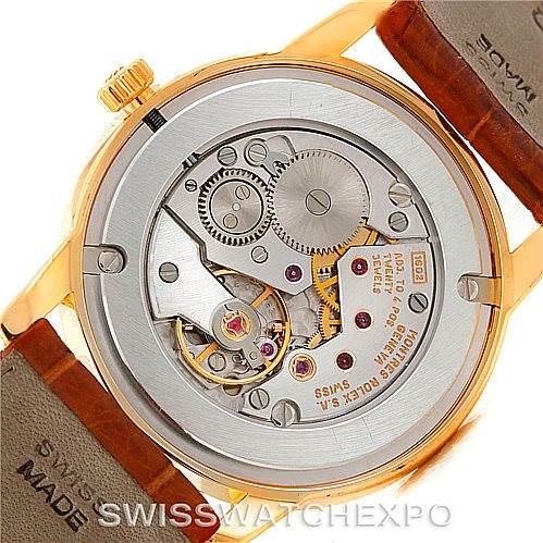This image shows the back view of a Rolex Cellini 5116 Men's Yellow Gold Champagne Dial 5116 Men's Yellow Gold Champagne Dial watch, revealing the intricate mechanical movement inside.