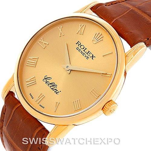 The image shows a Rolex Cellini 5116 Men's Yellow Gold Champagne Dial 5116 Men's Yellow Gold Champagne Dial model watch at an angled view, highlighting its gold case, dial, and brown leather strap.