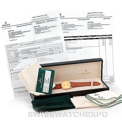 The Rolex Cellini 5116 Men's Yellow Gold Champagne Dial 5116 Men's Yellow Gold Champagne Dial watch is shown from the front with its box, papers, and accessories on display.