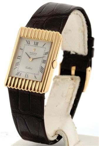 The image shows a Rolex Cellini 4016 Men's Yellow Gold White Dial 4016 Men's Yellow Gold White Dial watch at a tilted angle, highlighting its rectangular dial, leather strap, and gold-tone bezel.