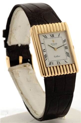 The Rolex Cellini 4016 Men's Yellow Gold White Dial 4016 Men's Yellow Gold White Dial watch is shown from a front angle, displaying its rectangular face, gold bezel, and leather strap.