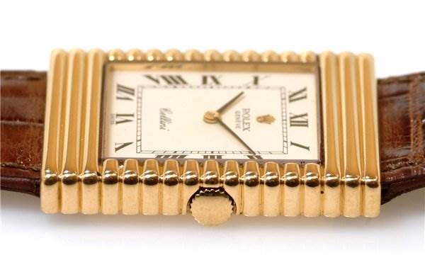 The image shows a close-up view of the face and crown of a Rolex Cellini 4012 Men's Yellow Gold White Dial 4012 Men's Yellow Gold White Dial watch, featuring its gold case and leather strap.