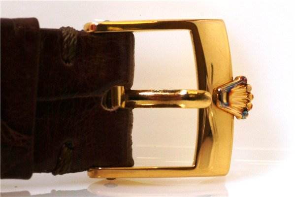 This image shows the gold buckle clasp with a Rolex logo and part of the leather strap of the Rolex Cellini 4012 Men's Yellow Gold White Dial 4012 Men's Yellow Gold White Dial watch.